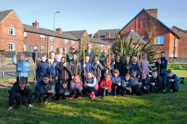 Year five pupils dig in at Chattering Fields, Howe Bridge, with assistance from Coun Susan Loudon and officers from the council's environmental education team