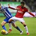 Thelo Aasgaard fights off the advances of United captain Bruno Fernandes