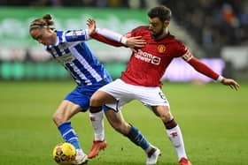 Thelo Aasgaard fights off the advances of United captain Bruno Fernandes