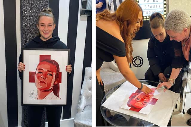 Ella Toone with the portrait that will be raffled off for BHF