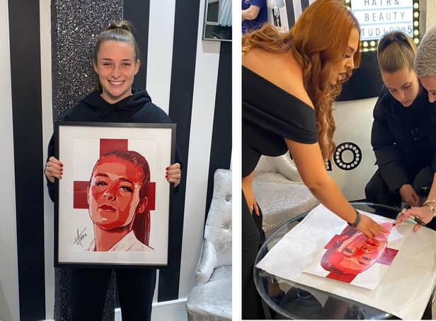 Ella Toone with the portrait that will be raffled off for BHF