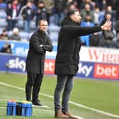 Huddersfield interim head coach Narcís Pelach tries to make his point as Shaun Maloney watches on
