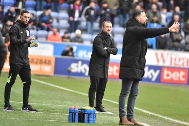 Huddersfield interim head coach Narcís Pelach tries to make his point as Shaun Maloney watches on