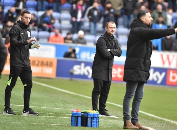 Huddersfield interim head coach Narcís Pelach tries to make his point as Shaun Maloney watches on