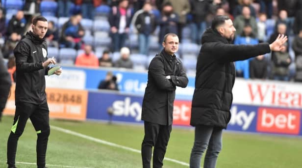 Huddersfield interim head coach Narcís Pelach tries to make his point as Shaun Maloney watches on