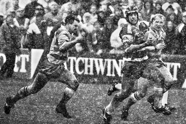 Wigan forward Phil Clarke makes a break through the blizzard to set up Sam Panapa for a try against Halifax in the Challenge Cup quarter-final at Thrum Hall on Sunday 28th of February 1993.  Wigan won 19-18.