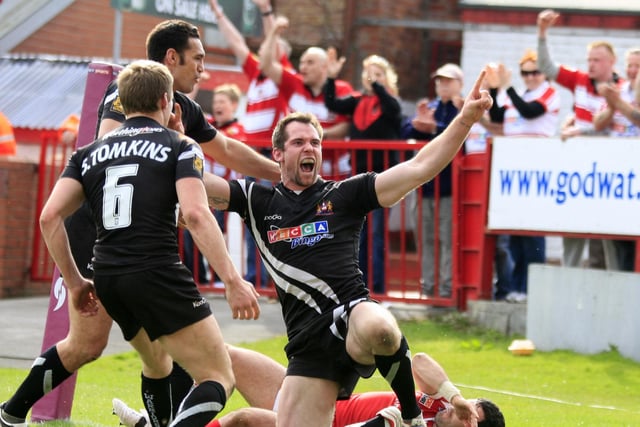 Richards celebrates scoring a try against Salford.