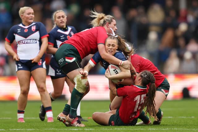England's Lacey Owen in action with Wales’ Brogan Evans at Headingley Stadium, Leeds