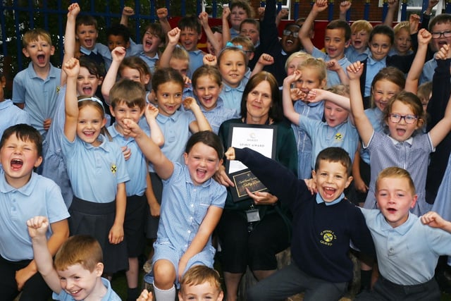 Teaching assistant Shelley Dowd was presented with the Spirit Award, after a number of colleagues commented that 'nothing is too much trouble' and 'She takes great pride in everything she does and settles for nothing less that excellent' - pictured with pupils excited to celebrate the award with her.