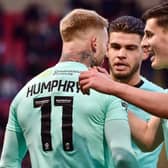 Omar Rekik and Kell Watts congratulate Stephen Humphrys after his equalising goal