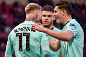 Omar Rekik and Kell Watts congratulate Stephen Humphrys after his equalising goal