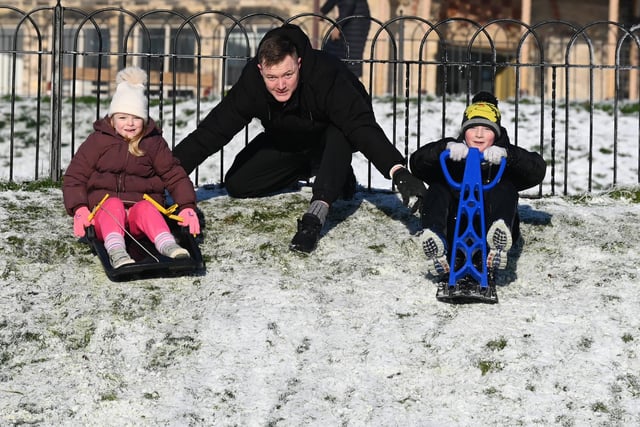 Wigan snow scenes - People make the most of the winter weather as snow falls on Mesnes Park, Wigan.