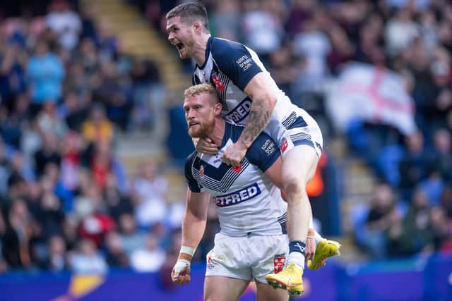 John Bateman celebrates with Luke Thompson