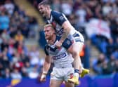 John Bateman celebrates with Luke Thompson