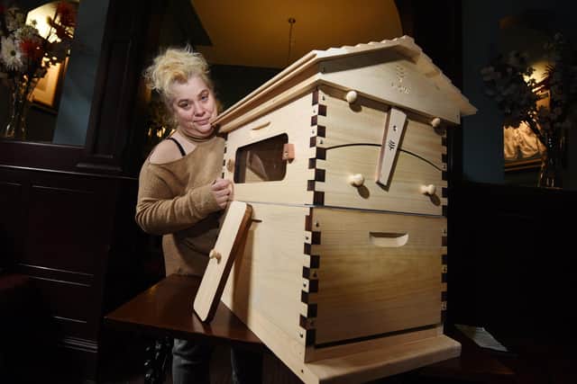 Shelley Wright with one of the beehives