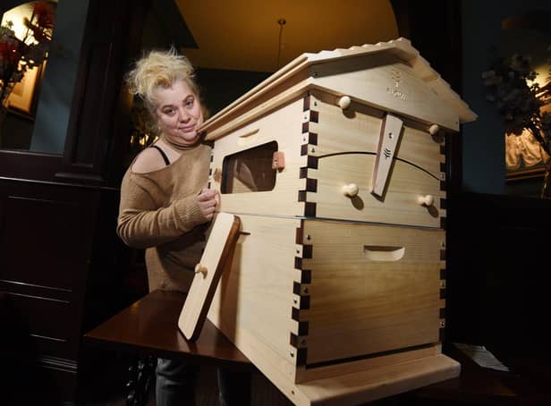 Shelley Wright with one of the beehives