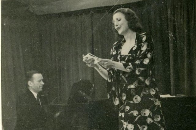 Margery Booth, born in Hodges Street in 1906, is the extraordinary opera singer-turned-spy who played an important role in the nation’s war effort and famously performed for Hitler. She gathered valuable information for the Allies during World War Two and was last year honoured by Wigan Council with a blue plaque. She is pictured here wearing a specially-made dress by Hardy Amies singing at Genshagen  prisoner of war camp in 1944.