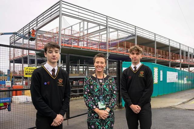 St John Fisher Catholic High School Head Teacher Alison Rigby with Head Prefects Flynn and George in front of the new main teaching block which is under construction.