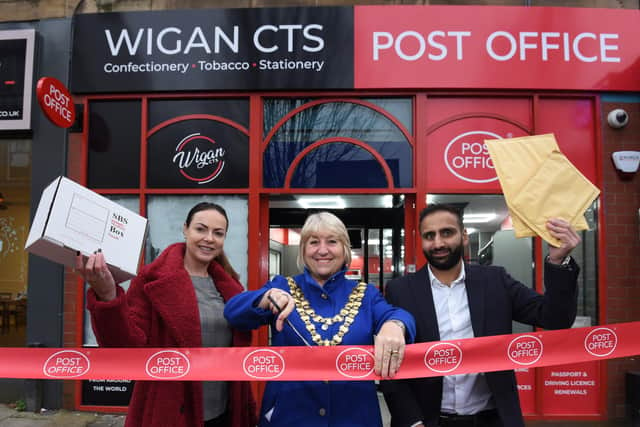 Coun Morgan, centre, cuts the ribbon. She is pictured with Post Office area manager Victoria Allsop, left, and postmaster Arif Matadar, right. The new permanent outlet is on Market Street.