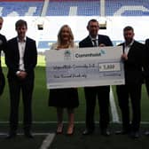 Representatives from Commhoist and Wigan Athletic Community trust with first team players Jack Whatmough, far left and Thelo Aasgaard, far right