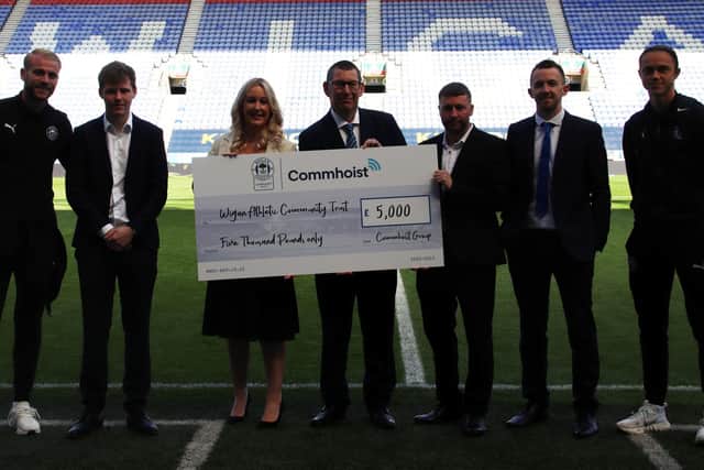 Representatives from Commhoist and Wigan Athletic Community trust with first team players Jack Whatmough, far left and Thelo Aasgaard, far right