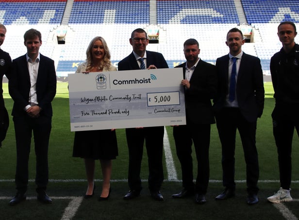 Representatives from Commhoist and Wigan Athletic Community trust with first team players Jack Whatmough, far left and Thelo Aasgaard, far right