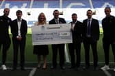 Representatives from Commhoist and Wigan Athletic Community trust with first team players Jack Whatmough, far left and Thelo Aasgaard, far right