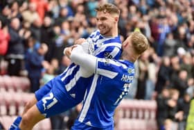 Scott Smith takes the congratulations from Stephen Humphrys after scoring the only goal against Blackpool