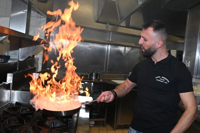 Cooking up a storm in the kitchen, one of the three co-owners, Sevdim Ibram.