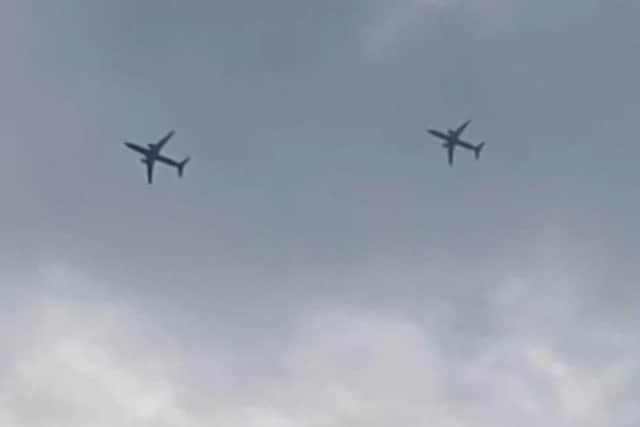 Two commercial airliners soar through the skies of Wigan seemingly in close formation