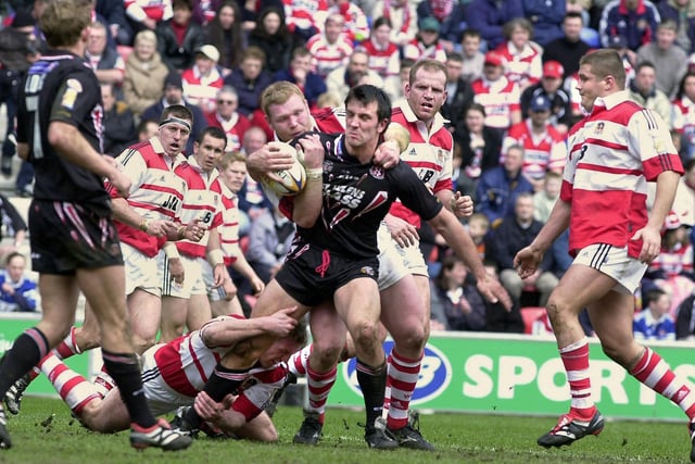 Paul Sculthorpe is held back by Neil Cowie and Denis Betts during Wigan Warriors Good Friday Super League clash against St. Helens at the JJB Stadium on 13th of April 2001.
The match was a 22-22 draw.