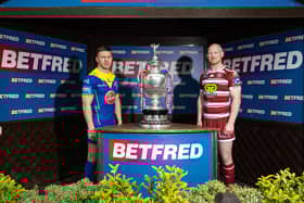 Warrington star George Williams and Wigan captain Liam Farrell pictured with the Challenge Cup trophy ahead of the final on Saturday