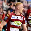 Zach Eckersley (left) and Jacob Douglas (right) celebrate a Wigan Warriors try