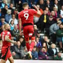 Charlie Wyke celebrates scoring his and Latics' second goal at Derby