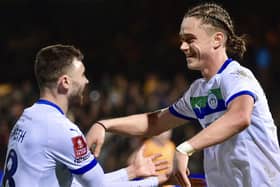 Goalscorers Jonny Smith and Thelo Aasgaard celebrate Latics' victory at Cambridge
