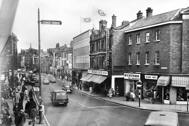 The lower end of Standishgate in 1966. Prominent are the C&A store, Mark Williams butchers, Hunters chemist and Bellmans Wools.