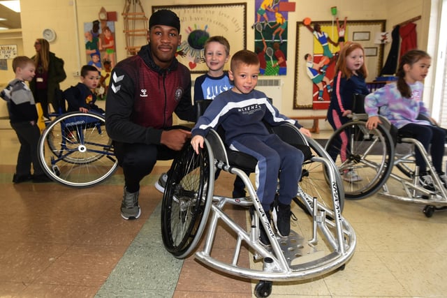 Pupils learn wheelchair rugby skills.