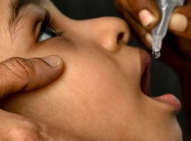A health worker administers oral polio vaccine to a child during a vaccination drive as a part of an ongoing polio eradication program in Chennai on February 27, 2022. (Photo by Arun SANKAR / AFP) (Photo by ARUN SANKAR/AFP via Getty Images)
