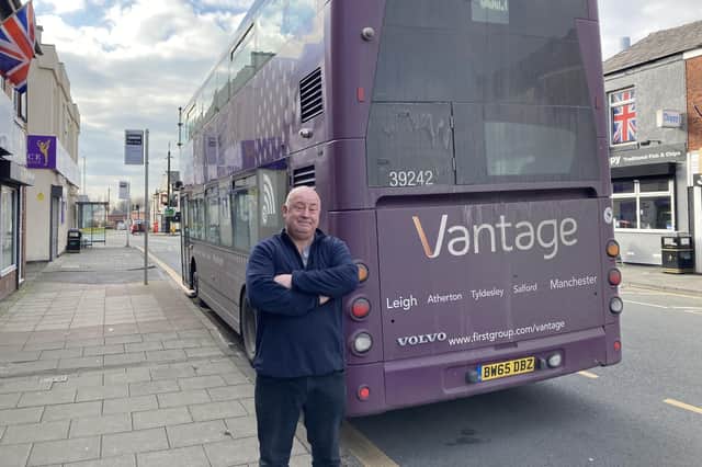Atherton Tackle owner Kevin Jones unimpressed with a Vantage bus parked in front of his shop in Atherton