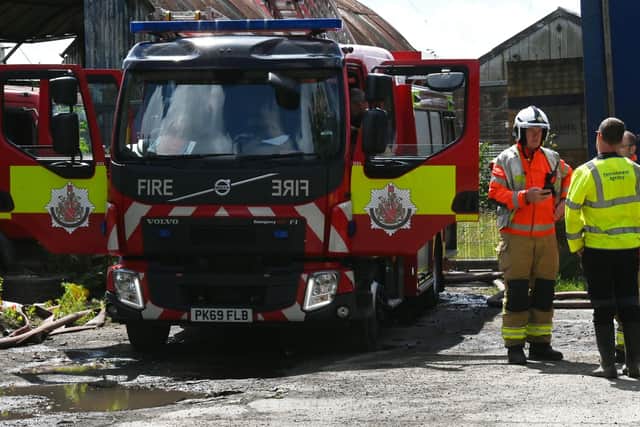 Members of Greater Manchester Fire and Rescue Service and the Environment Agency at the scene of the fire on Bolton House Road, Bickershaw
