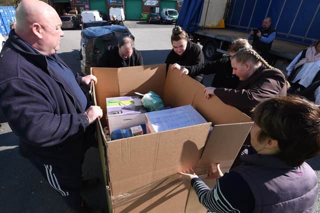 Pupils from the School Council at Orrell St James' RC primary school join staff at BA Berry Builders at Hewitt Business Park, Orrell, to help pack and load the food and items donated to send to Ukraine.