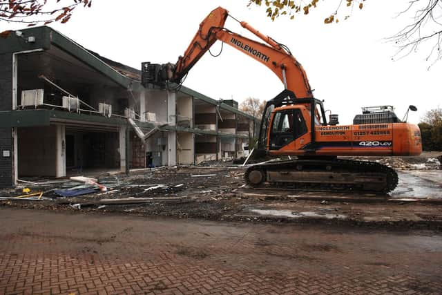 Demolition experts taking apart the old Abraham Guest High School in 2010