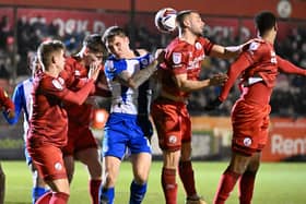 Jason Kerr tries to get his head to a Latics set-piece