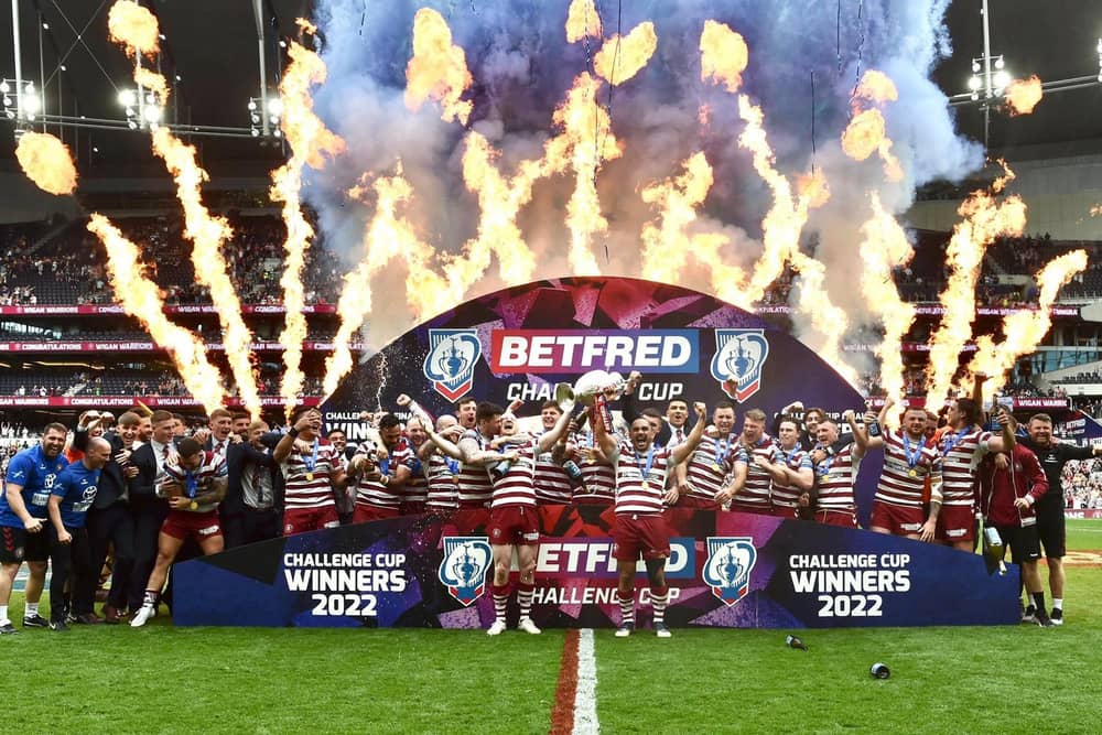 The Wigan Warriors players celebrate winning the Challenge Cup
