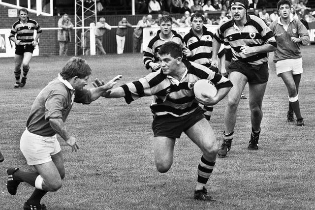Paul Manley handing off with Dave Cusani close behind during a Courage League 1 match against London Irish at Edge Hall Road on Saturday 2nd of September 1989.
Orrell won 26-6.