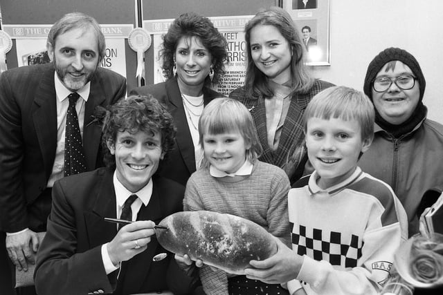 Using his loaf to sign his autograph for fans is actor Jonathon Morris who played Adrian Boswell in the television comedy "Bread".  Jonathon was in Wigan to open a new branch of the Co-Operative bank in Market Street  on Saturday 11th of February 1989.