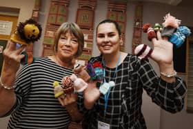 Kim Beardsmore from Age UK Wigan Borough, right, with Kath Lewin, left, from Daisy Chain Stitches,  the group meet every Tuesday afternoon at Clifton Street Community Centre, Poolstock, have been busy making little knitted hats to go on Innocent Smoothie bottles in partnership and raising funds for Age UK, the group have made about 600  so far.