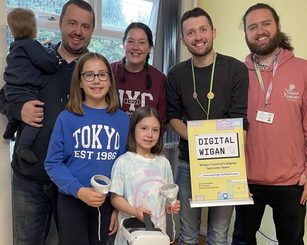 Daniel and Eleanor Cunningham with Darcy, 10, Ebony, seven, Blake, one and Alex Yoxall and Ben Yoxall from Wigan Council