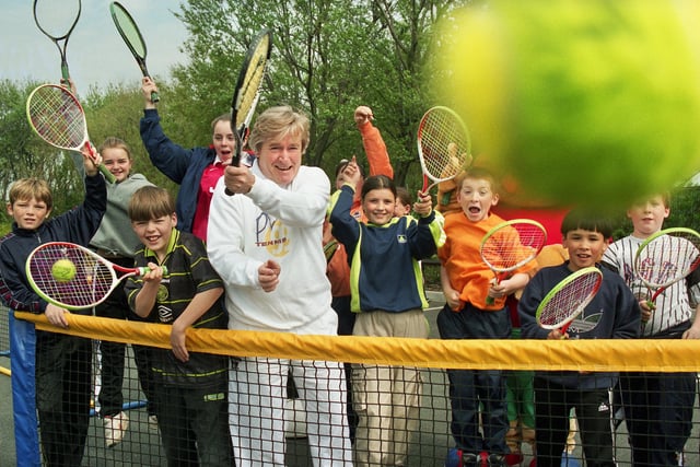 Coronation Street's Ken Barlow, alias actor Bill Roach, serves up an ace with pupils of St. Edward's RC Primary School, Newtown, as he launched Play Tennis 99 at Robin Park on Friday 7th of May 1999.  The day was part of Britain's biggest tennis promotion to encourage people to take up the sport.