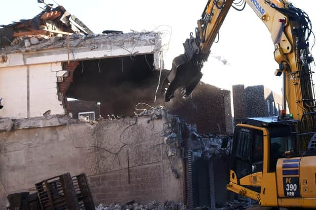 Heavy machinery at work demolishing buildings part of The Galleries redevelopement of Wigan town centre.